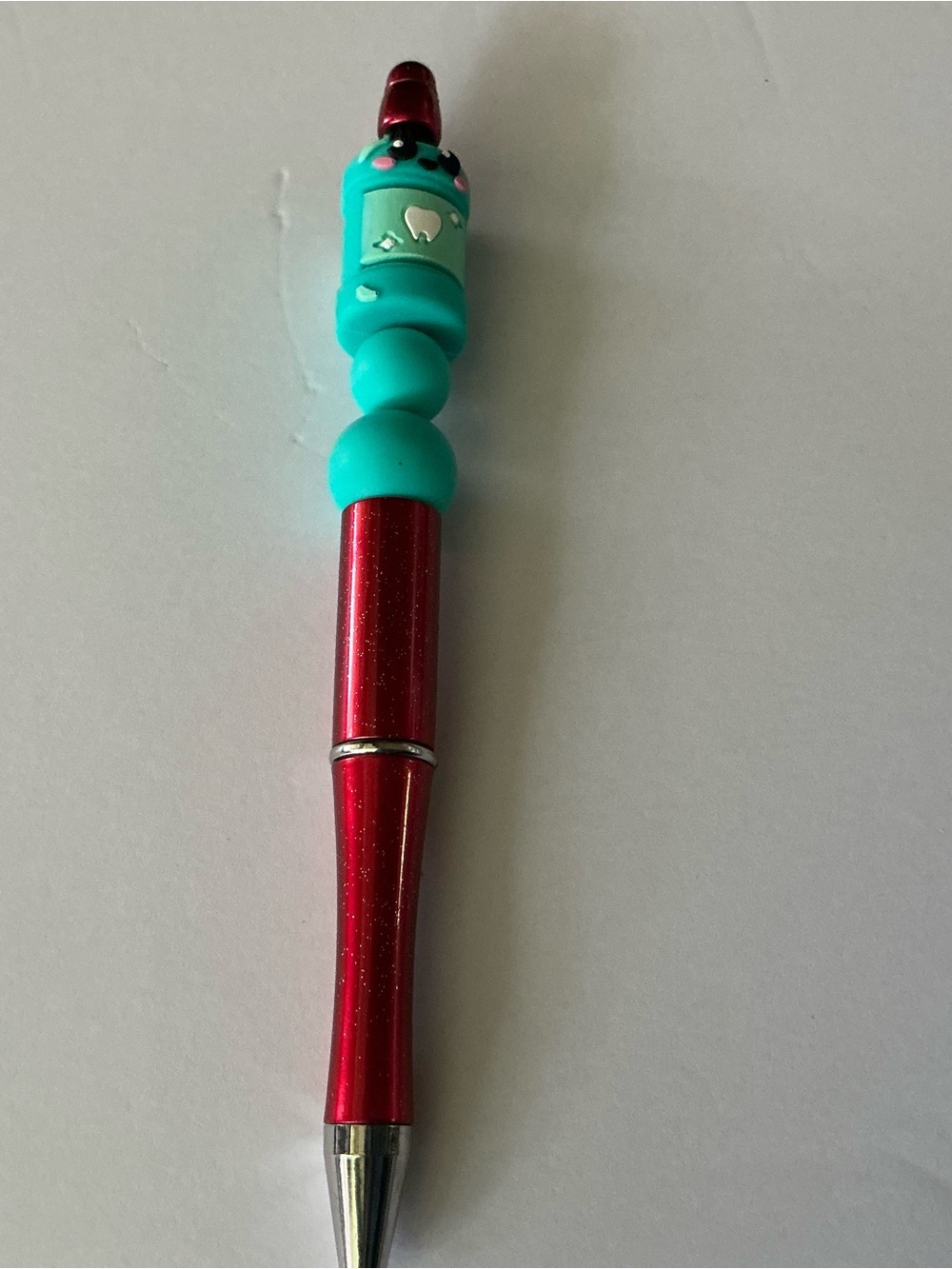 Red Ballpoint Pen with Teal Character Top For Dental Professionals